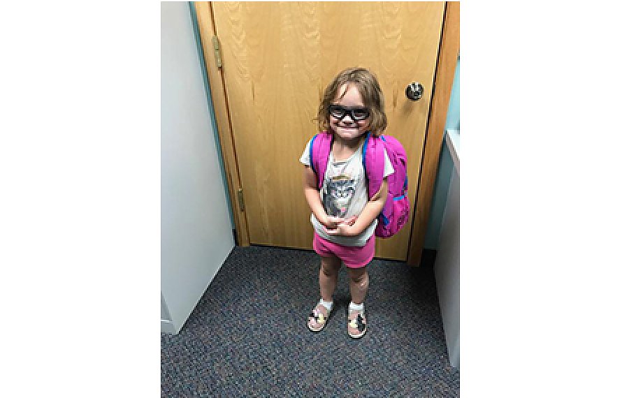 Ariah showing off her backpack at Comprehensive Rehab