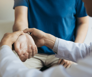 Physical therapist checking the wrist of a patient