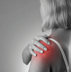 A woman clutching her shoulder in pain
