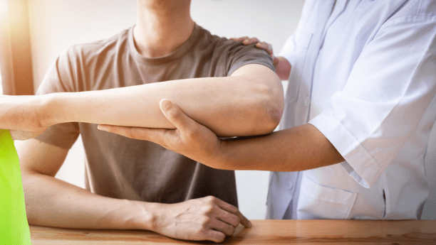 doctor working with a patient on shoulder mobility